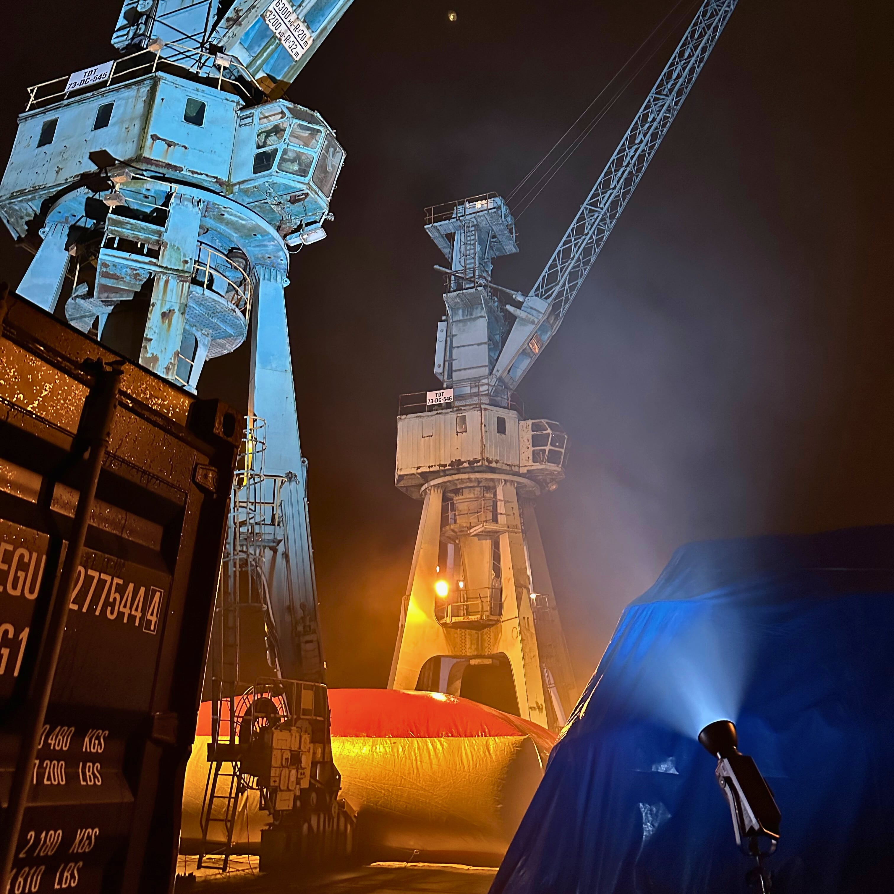 airbag between cranes by night